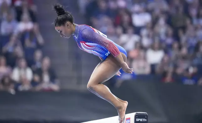 Simone Biles bobbles and falls off the balance beam at the United States Gymnastics Olympic Trials on Sunday, June 30, 2024, in Minneapolis. (AP Photo/Charlie Riedel)
