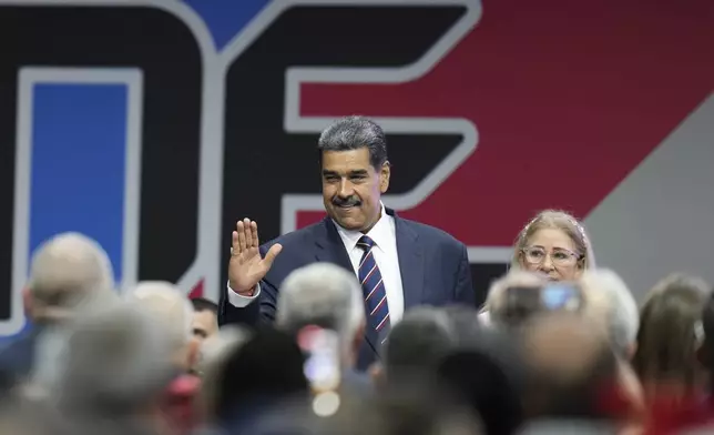 Venezuelan President Nicolas Maduro arrives with his wife Cilia Flores for a ceremony where the National Electoral Council (CNE) certifies that he won the presidential election, at the CNE in Caracas, Venezuela, Monday, July 29, 2024. (AP Photo/Matias Delacroix)