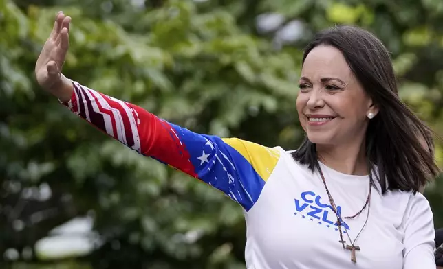 Opposition leader Maria Corina Machado waves from atop a truck during the closing election campaign rally for presidential candidate Edmundo Gonzalez in Caracas, Venezuela, Thursday, July 25, 2024. The presidential election is set for July 28. (AP Photo/Matias Delacroix)