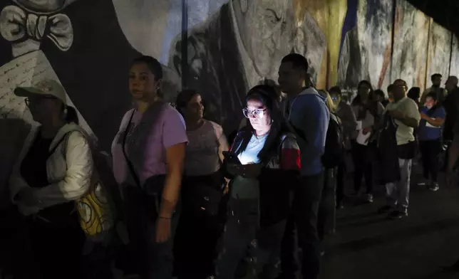 Voters line up at a voting station prior to the opening of the polls for presidential elections in Caracas, Venezuela, Sunday, July 28, 2024. (AP Photo/Cristias Hernandez)