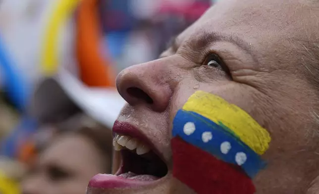 A supporter of opposition presidential candidate Edmundo Gonzalez cheers as thousnads wait for his arrival at a campaign rally in Barinas, Venezuela, Saturday, July 6, 2024. The official campaign period for the July 28 election kicked off on July 4. (AP Photo/Ariana Cubillos)