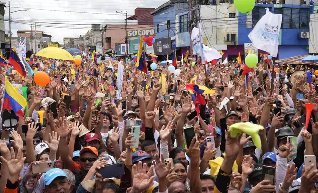 Supporters of opposition presidential candidate Edmundo Gonzalez raise their hands in unison at a campaign rally in Barinas, Venezuela, Saturday, July 6, 2024. (AP Photo/Ariana Cubillos)