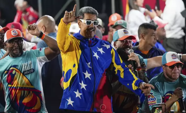 President Nicolas Maduro dances outside the Miraflores presidential palace after electoral authorities declared him the winner of the presidential election in Caracas, Venezuela, Monday, July 29, 2024. (AP Photo/Fernando Vergara)