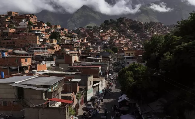 Voters line up during presidential elections at a polling station in Petare neighborhood, Caracas, Venezuela, Sunday, July 28, 2024. (AP Photo/Matias Delacroix)