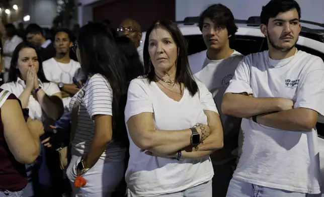 Supporters of opposition presidential candidate Edmundo Gonzalez gather outside his campaign headquarters after the polls closed for the presidential election in Caracas, Venezuela, Sunday, July 28, 2024. (AP Photo/Cristian Hernandez)