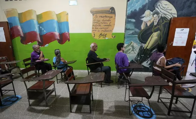 Voters wait to cast their ballots during presidential elections in Caracas, Venezuela, Sunday, July 28, 2024. (AP Photo/Fernando Vergara)