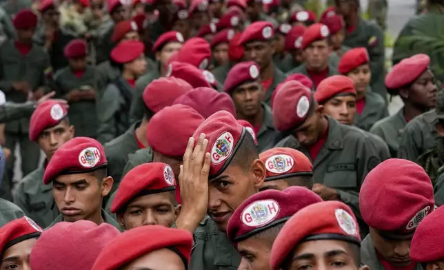 Members of the presidential guar line up to vote during presidential elections in Caracas, Venezuela, Sunday, July 28, 2024. (AP Photo/Matias Delacroix)