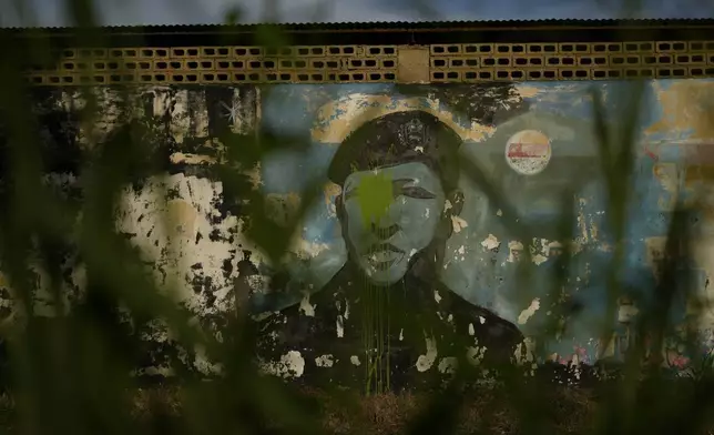 An image of late President Hugo Chavez looks out from a mural on a wall in Barinas, Venezuela, Sunday, July 7, 2024. Venezuela is set to hold a presidential election on July 28. (AP Photo/Ariana Cubillos)