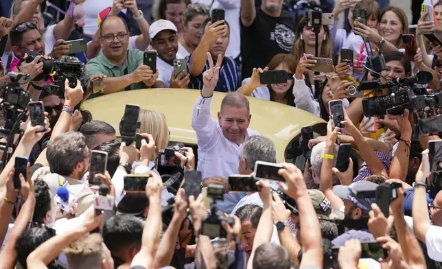 The opposition's presidential candidate Edmundo Gonzalez flashes a victory sign as he arrives to vote in the presidential election in Caracas, Venezuela, Sunday, July 28, 2024. (AP Photo/Matias Delacroix)