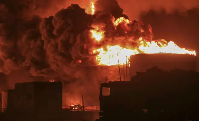 Oil tanks burn at the port in Hodeidah, Yemen, Saturday, July 20, 2024. The Israeli army said it has struck several Houthi targets in western Yemen following a fatal drone attack by the rebel group in Tel Aviv the previous day. (AP Photo)