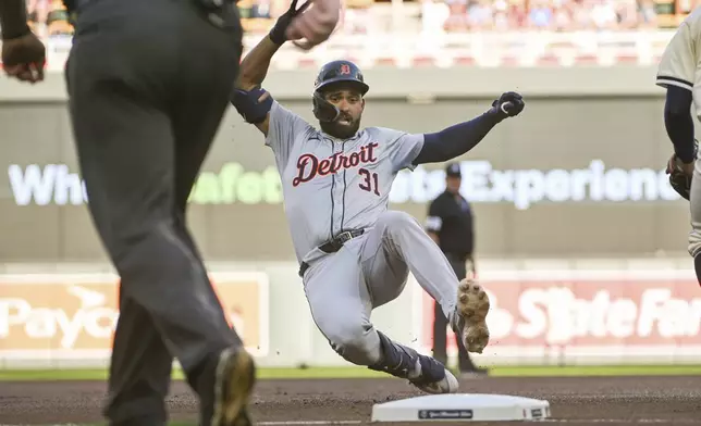 Detroit Tigers' Riley Greene slides into third base on a triple hit against Minnesota Twins starting pitcher David Festa during the first inning of a baseball game Wednesday, July 3, 2024, in Minneapolis. (AP Photo/Craig Lassig)