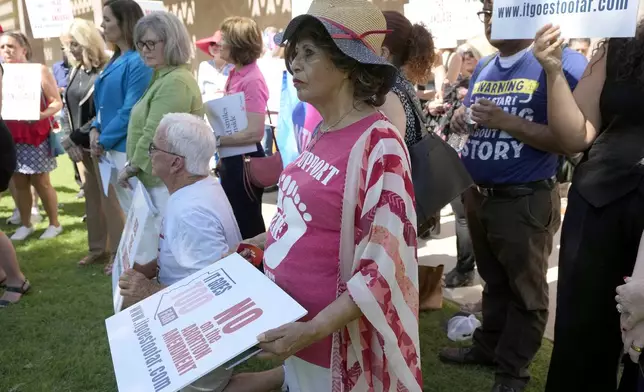 Anti-abortion protesters gather for a news conference after Arizona abortion-rights supporters deliver over 800,000 petition signatures to the capitol to get abortion rights on the November general election ballot Wednesday, July 3, 2024, in Phoenix. (AP Photo/Ross D. Franklin)