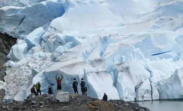 FILE - A group of people take in the views of the Mendenhall Glacier on June 8, 2023, in Juneau, Alaska. Voters in Alaska's capital city could decide in October whether to ban large cruise ships on Saturdays starting next year. Supporters of the proposal say it would give residents a reprieve from the crush of tourists drawn to attractions like Juneau's fast-retreating Mendenhall Glacier, but opponents say it would hurt local businesses and invite lawsuits. (AP Photo/Becky Bohrer, File)