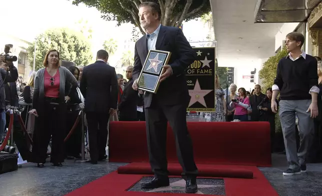 FILE - Alec Baldwin poses after he received a star on the Hollywood Walk of Fame in Los Angeles on Monday, Feb. 14, 2011. Baldwin is going on trial for involuntary manslaughter after nearly 35 years in the public eye. (AP Photo/Matt Sayles, File)