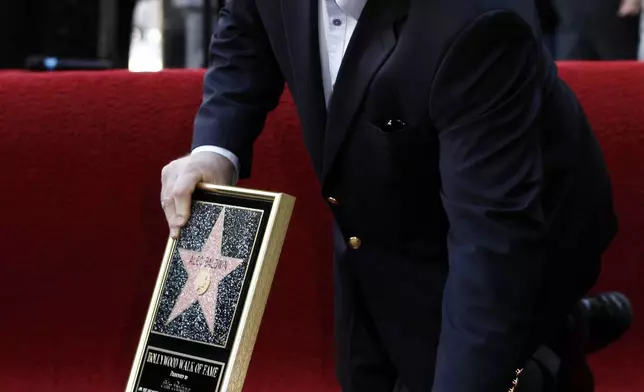 FILE - Alec Baldwin poses after he received a star on the Hollywood Walk of Fame in Los Angeles on Monday, Feb. 14, 2011. Baldwin is going on trial for involuntary manslaughter after nearly 35 years in the public eye. (AP Photo/Matt Sayles, File)