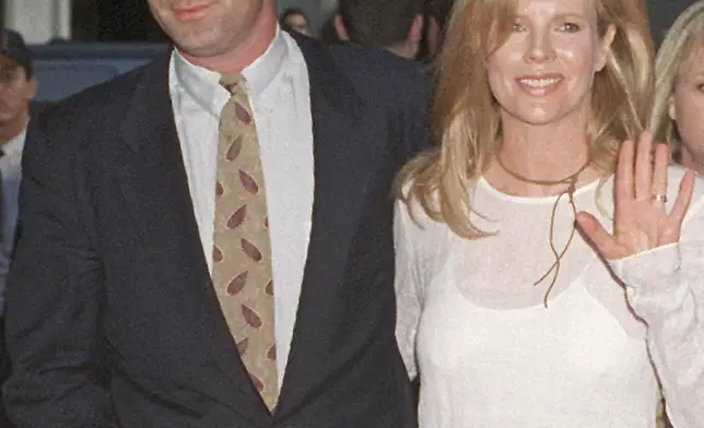 FILE - Actress Kim Basinger is shown in a June 26, 1994 photo with her husband actor Alec Baldwin. Baldwin is going on trial for involuntary manslaughter after nearly 35 years in the public eye. The actor began his career in soap operas before moving on to movies and other roles in 1988. (AP Photo, File)