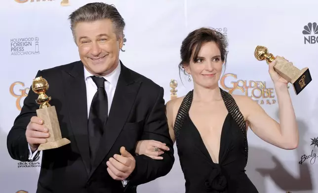 FILE - Alec Baldwin, left, winner of the best actor in a television series, comedy or musical for "30 Rock", and fellow cast member Tina Fey, winner of best actress in a television series, comedy or musical pose backstage with their awards at the 66th Annual Golden Globe Awards on Sunday, Jan. 11, 2009, in Beverly Hills, Calif. (AP Photo/Mark J. Terrill, File)