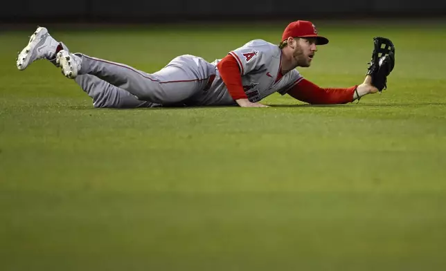 Los Angeles Angels outfielder Taylor Ward (3) makes a diving catch against the Oakland Athletics during the sixth inning of a baseball game Tuesday, July 2, 2024, in Oakland, Calif. (AP Photo/Eakin Howard)