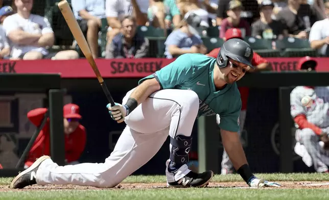 Seattle Mariners catcher Cal Raleigh takes a hard spin on a swing in the third inning against the Los Angeles Angels, Wednesday, July 24, 2024, in Seattle. (Kevin Clark/The Seattle Times via AP)