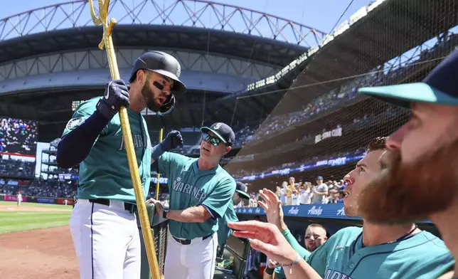 Seattle Mariners' Mitch Haniger celebrates his home in the second inning of a baseball game against the Los Angeles Angels, Wednesday, July 24, 2024, in Seattle. (Kevin Clark/The Seattle Times via AP)