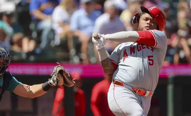 Los Angeles Angels' Willie Calhoun swings and misses during the sixth inning of a baseball game against the Seattle Mariners, Wednesday, July 24, 2024, in Seattle. (Kevin Clark/The Seattle Times via AP)