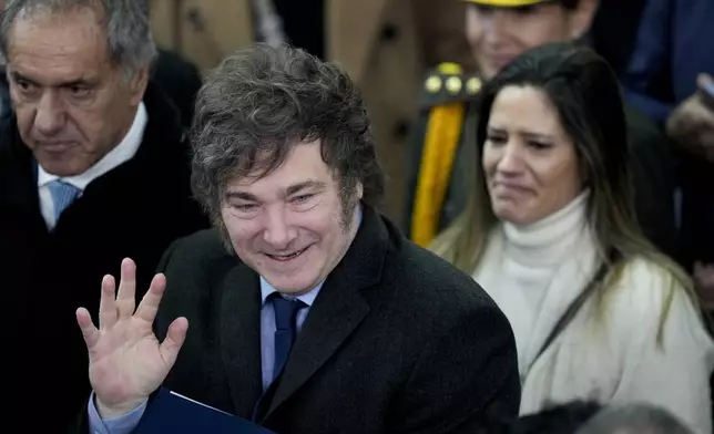 President Javier Milei waves as he departs from a ceremony to greet the athletes who will compete in the Paris Olympic Games, in Buenos Aires, Argentina, Friday, July 5, 2024. (AP Photo/Natacha Pisarenko)