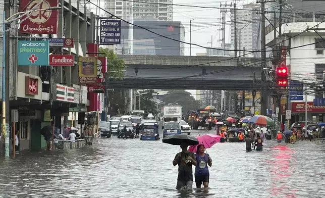 Streets flood from monsoon rains worsened by offshore typhoon Gaemi on Wednesday, July 24, 2024, in Manila, Philippines. (AP Photo/Joeal Capulitan)