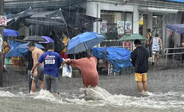 Streets flood from monsoon rains worsened by offshore typhoon Gaemi on Wednesday, July 24, 2024, in Manila, Philippines. (AP Photo/Joeal Capulitan)