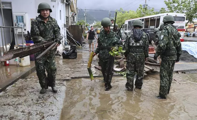 In this photo released by the Taiwan Ministry of National Defense, Taiwanese soldiers clear debris in the aftermath of Typhoon Gaemi in Kaohsiung county in southwestern Taiwan, Friday, July 26, 2024. (Taiwan Ministry of National Defense via AP)