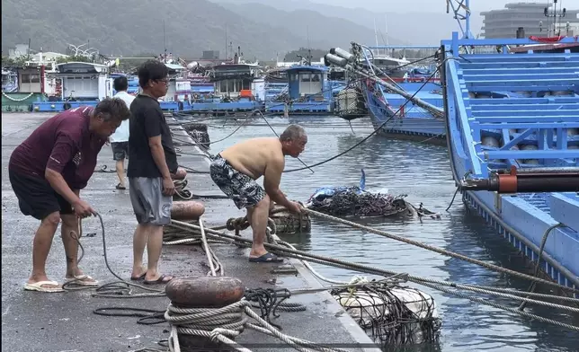 Fishermen prepare to secure their boats in Wushi harbor before typhoon Gaemi makes landfall in northeastern Taiwan's Yilan county on Wednesday, Nov. 24, 2024. Taiwan has shuttered offices, schools and tourist sites across the island ahead of a powerful typhoon due to make landfall later Wednesday. (AP Photo/Johnson Lai)