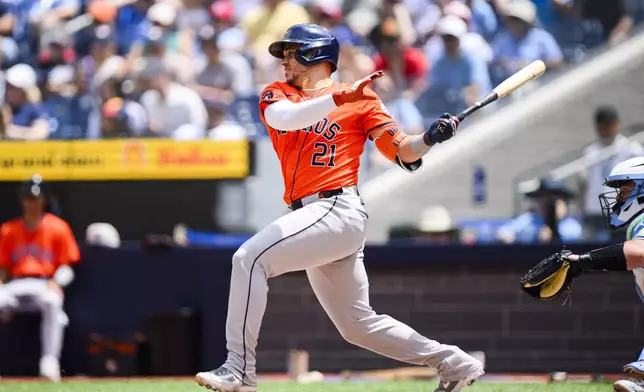 Houston Astros catcher Yainer Diaz (21) hits an RBI single during the first inning of a baseball game against the Toronto Blue Jays in Toronto on Thursday, July 4, 2024. (Christopher Katsarov/The Canadian Press via AP)