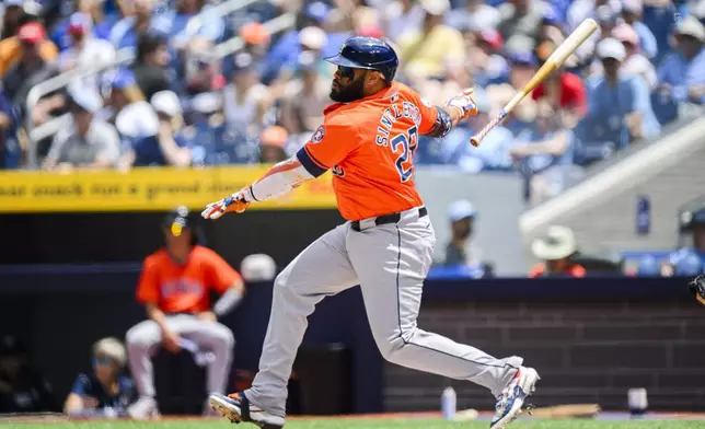 Houston Astros first base Jon Singleton (28) hits a line drive single during the first inning of a baseball game against the Toronto Blue Jays, in Toronto on Thursday, July 4, 2024. (Christopher Katsarov/The Canadian Press via AP)
