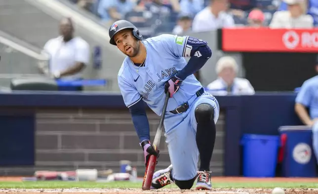 Toronto Blue Jays' George Springer looks on after swinging at a pitch during second-inning baseball game action against the Houston Astros in Toronto, Thursday, July 4, 2024. (Christopher Katsarov/The Canadian Press via AP)