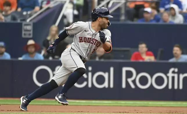 Houston Astros' Jose Altuve (27) runs back to first base after hitting a single against the Toronto Blue Jays during the first inning of a baseball game, Tuesday, July 2, 2024, in Toronto. (Jon Blacker/The Canadian Press via AP)