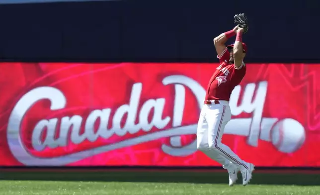 Toronto Blue Jays center fielder Kevin Kiermaier jumps to catch a pop fly by Houston Astros' Jeremy Pena during second-inning baseball game action in Toronto, Monday, July 1, 2024. (Frank Gunn/The Canadian Press via AP)