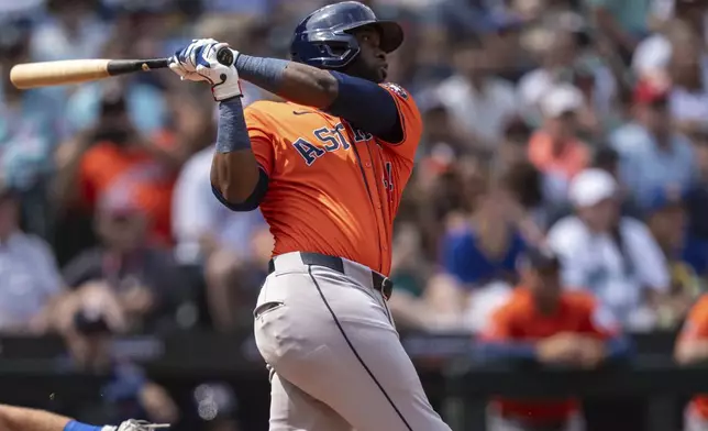 Houston Astros' Yordan Alvarez hits a one-run triple during the sixth inning of a baseball game against the Seattle Mariners, Sunday, July 21, 2024, in Seattle. (AP Photo/Stephen Brashear)