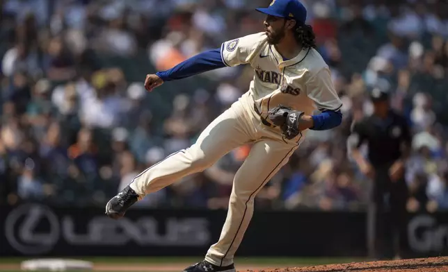 Seattle Mariners' Andres Munoz delivers a pitch during the ninth inning of a baseball game against the Houston Astros, Sunday, July 21, 2024, in Seattle. (AP Photo/Stephen Brashear)