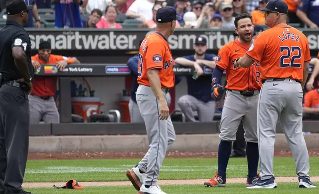 Houston Astros' Jose Altuve, second from right, argues on the field before being ejected by umpire James Jean during the seventh inning of a baseball game against the New York Mets, Sunday, June 30, 2024, in New York. (AP Photo/Pamela Smith)