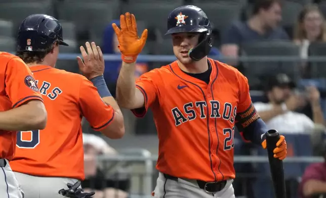 Houston Astros' Jake Meyers, left, and Chas McCormick, right celebrate after Meyers scored during the 11th inning of a baseball game against the Houston Astros, Sunday, June 30, 2024, in New York. (AP Photo/Pamela Smith)