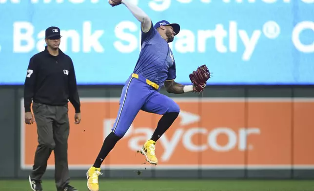 Minnesota Twins shortstop Carlos Correa, right, throws out Houston Astros' Jeremy Pena out at first during the fourth inning of a baseball game Friday, July 5, 2024, in Minneapolis. (AP Photo/Craig Lassig)