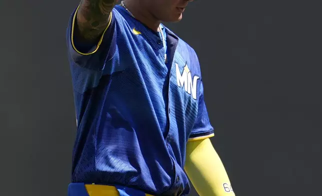 Minnesota Twins' Jose Miranda acknowledges the crowd after hitting a fly out to end his streak of 12 consecutive at-bats with a hit during the sixth inning of a baseball game against the Houston Astros Saturday, July 6, 2024, in Minneapolis. (AP Photo/Abbie Parr)