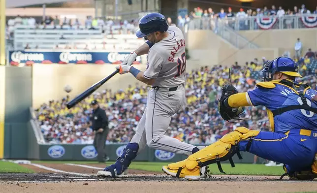 Houston Astros' Cesar Salazar (18) hits an RBI single, scoring Jonathan Singleton, as Minnesota Twins catcher Christian Vazquez (8) looks on during the second inning of a baseball game Friday, July 5, 2024, in Minneapolis. (AP Photo/Craig Lassig)