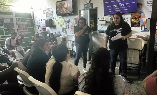 Melissa Shepard, directing attorney of Immigrant Defenders Law Center, explains the Biden administration's new asylum restrictions to migrants at the Juventud 2000 shelter in Tijuana, Mexico, on Monday, June 17, 2024. (AP Photo/Elliot Spagat)