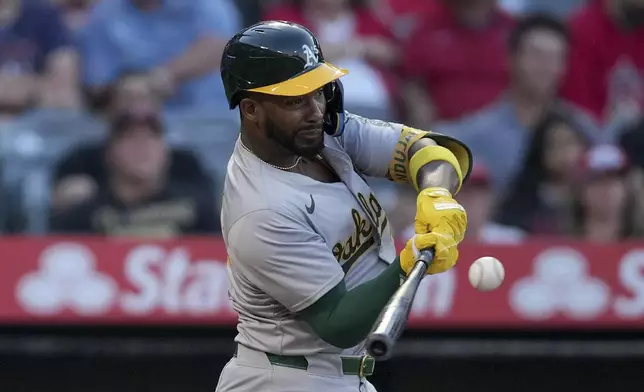 Oakland Athletics' Miguel Andujar flies out during the sixth inning of a baseball game against the Los Angeles Angels in Anaheim, Calif., Friday, July 26, 2024. (AP Photo/Eric Thayer)