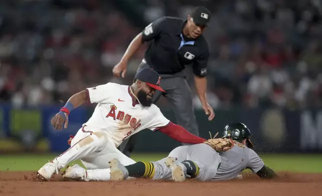 Los Angeles Angels second baseman Luis Rengifo (2) tags out Oakland Athletics' Shea Langeliers, right, who was trying to steal second during the eighth inning of a baseball game in Anaheim, Calif., Friday, July 26, 2024. (AP Photo/Eric Thayer)