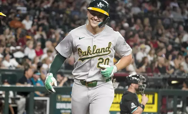 Oakland Athletics' Zack Gelof smiles after crossing home plate after hitting a solo home run against the Arizona Diamondbacks during the fifth inning of a baseball game Sunday, June 30, 2024, in Phoenix. (AP Photo/Darryl Webb)