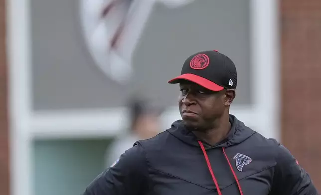 Atlanta Falcons head coach Raheem Morris watches an NFL training camp football practice Thursday, July 25, 2024, in Flowery Branch, Ga. (AP Photo/John Bazemore)