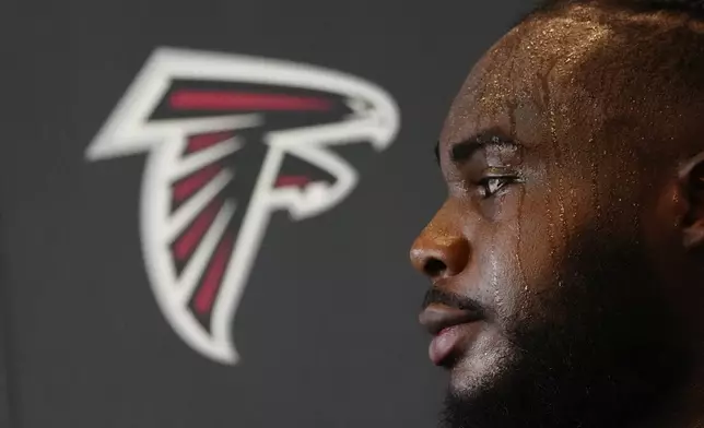 Atlanta Falcons defensive end Grady Jarrett speaks to the media after an NFL training camp football practice Thursday, July 25, 2024, in Flowery Branch, Ga. (AP Photo/John Bazemore)