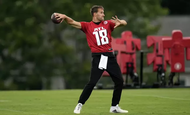 Atlanta Falcons quarterback Kirk Cousins throws during an NFL training camp football practice Thursday, July 25, 2024, in Flowery Branch, Ga. (AP Photo/John Bazemore)