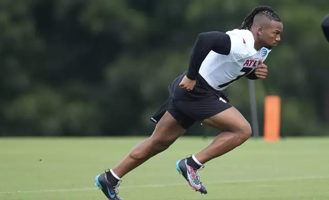 Atlanta Falcons running back Bijan Robinson runs a drill during an NFL training camp football practice Thursday, July 25, 2024, in Flowery Branch, Ga. (AP Photo/John Bazemore)